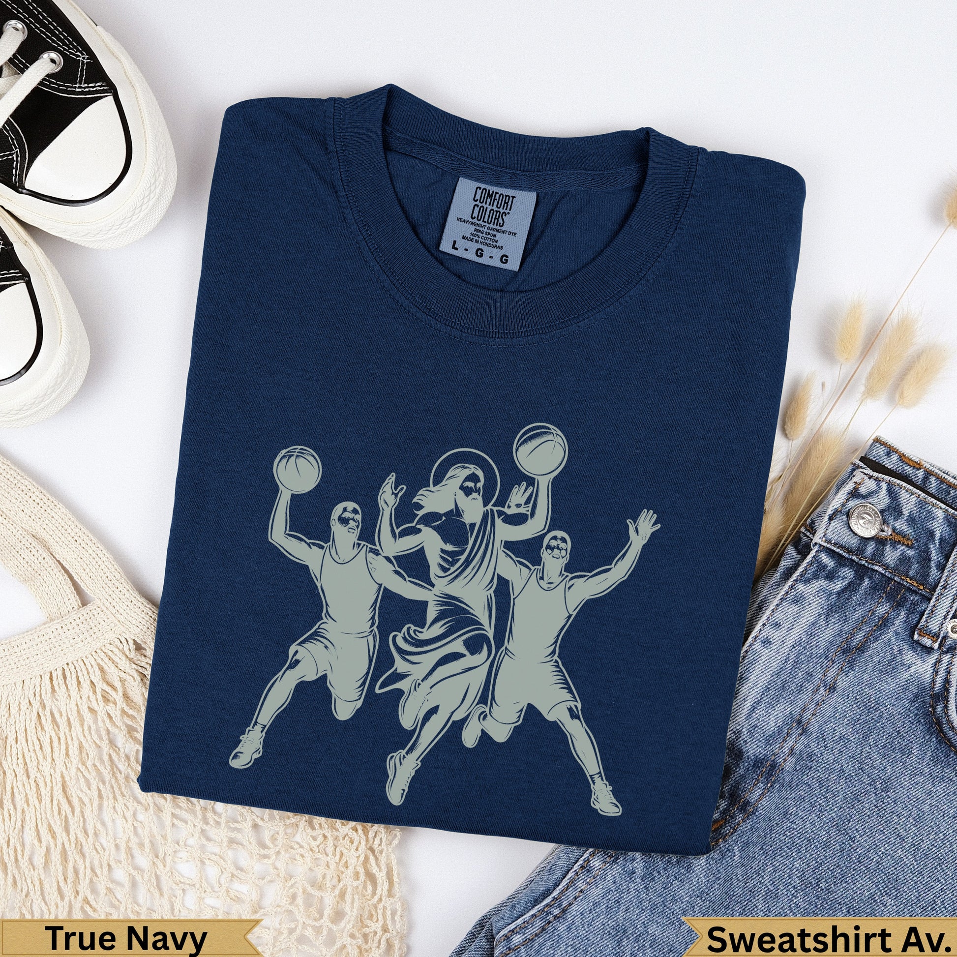 Jesus playing basketball with two players on a navy sweatshirt.