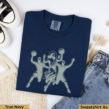 Jesus playing basketball with two players on a navy sweatshirt.