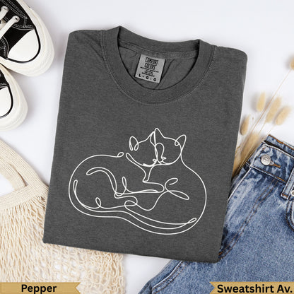 Charcoal sweatshirt with white line art of two cats cuddling, size L.