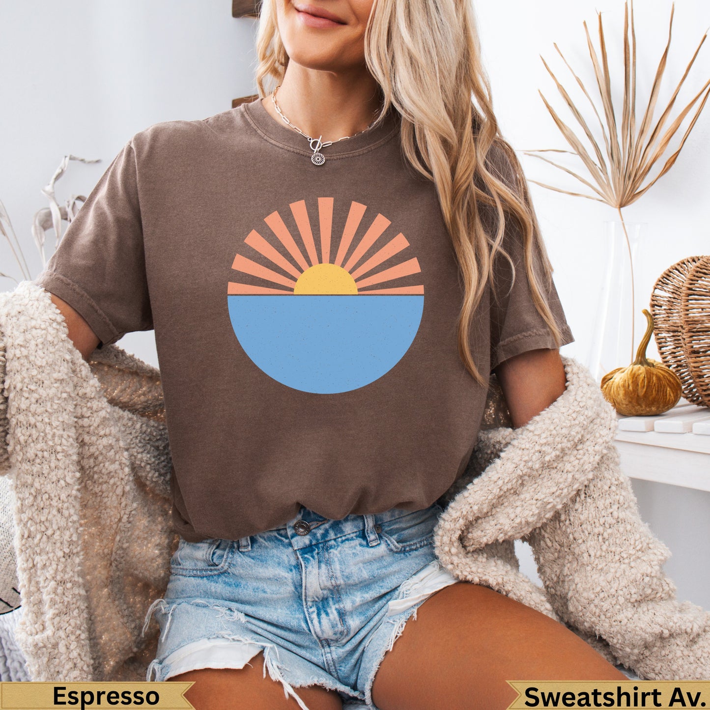 Brown t-shirt with a sunrise over water graphic and text.