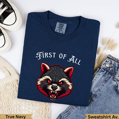 Navy t-shirt with a fierce raccoon graphic and "FIRST OF ALL" text.