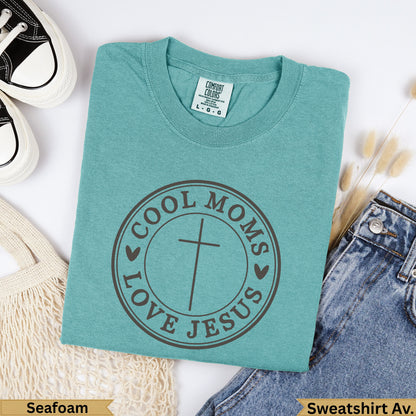 Teal Comfort Colors sweatshirt with "Cool Moms Love Jesus" circular graphic.