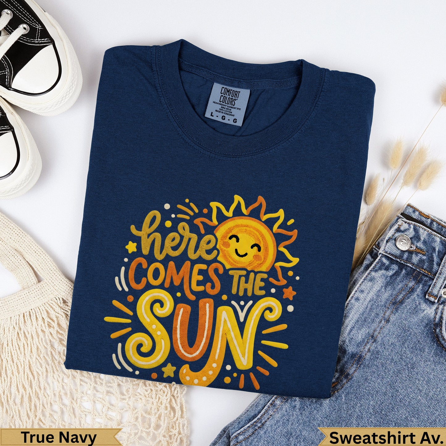 Navy blue t-shirt with "here comes the sun" text and a smiling sun graphic.