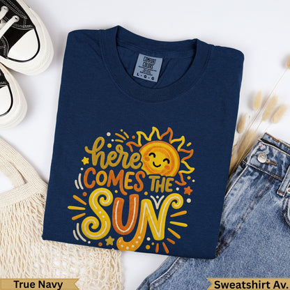 Navy blue t-shirt with "here comes the sun" text and a smiling sun graphic.