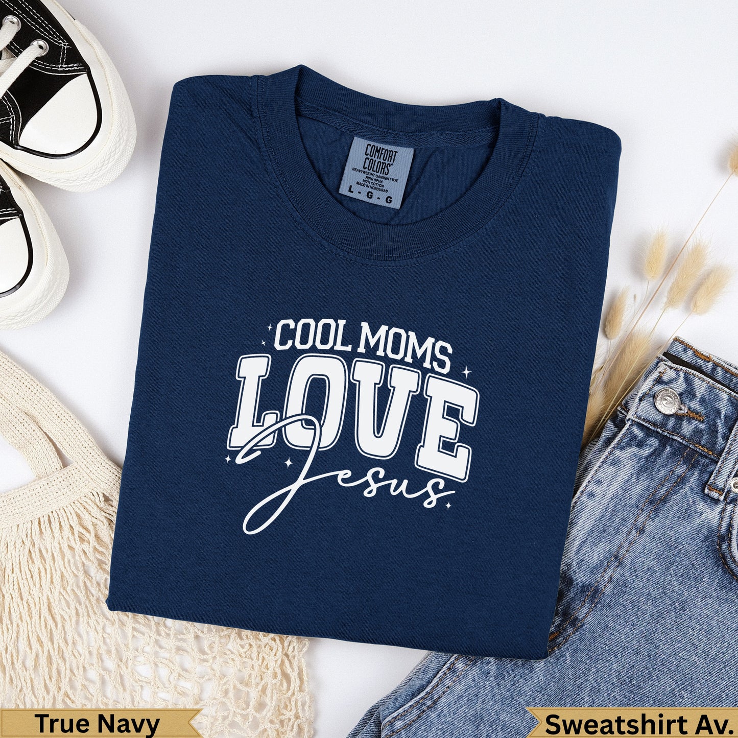 Navy blue "Cool Moms Love Jesus" graphic t-shirt on denim.