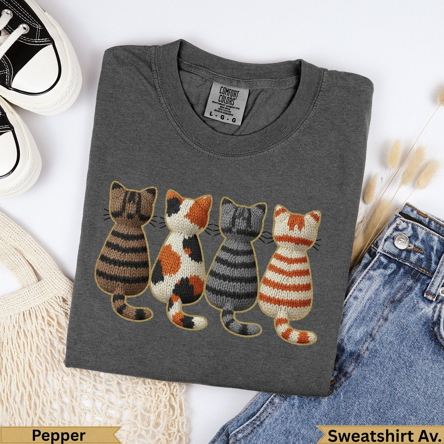 Dark gray sweatshirt with embroidered row of four cats: striped, calico, striped, striped.
