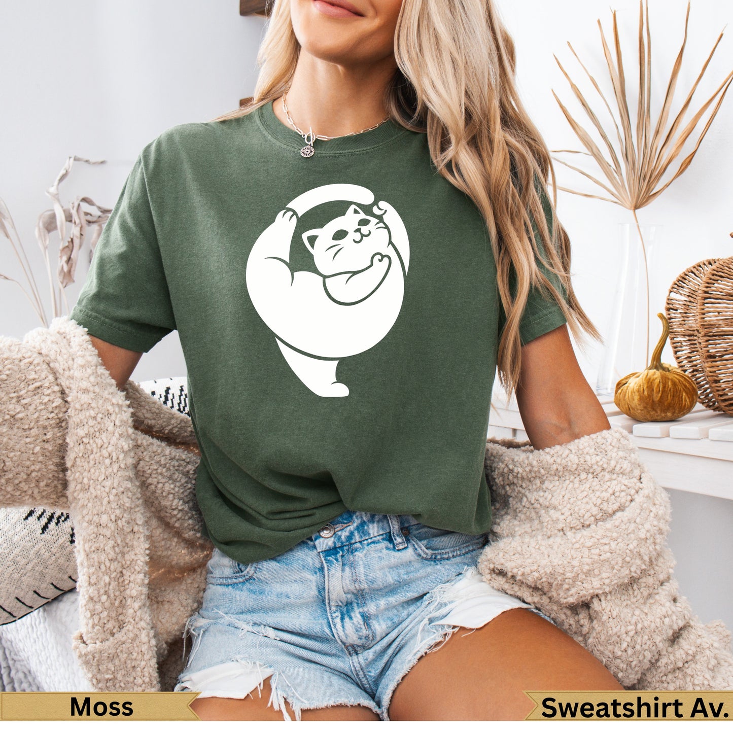 Green t-shirt with white cat yoga pose graphic on chest.