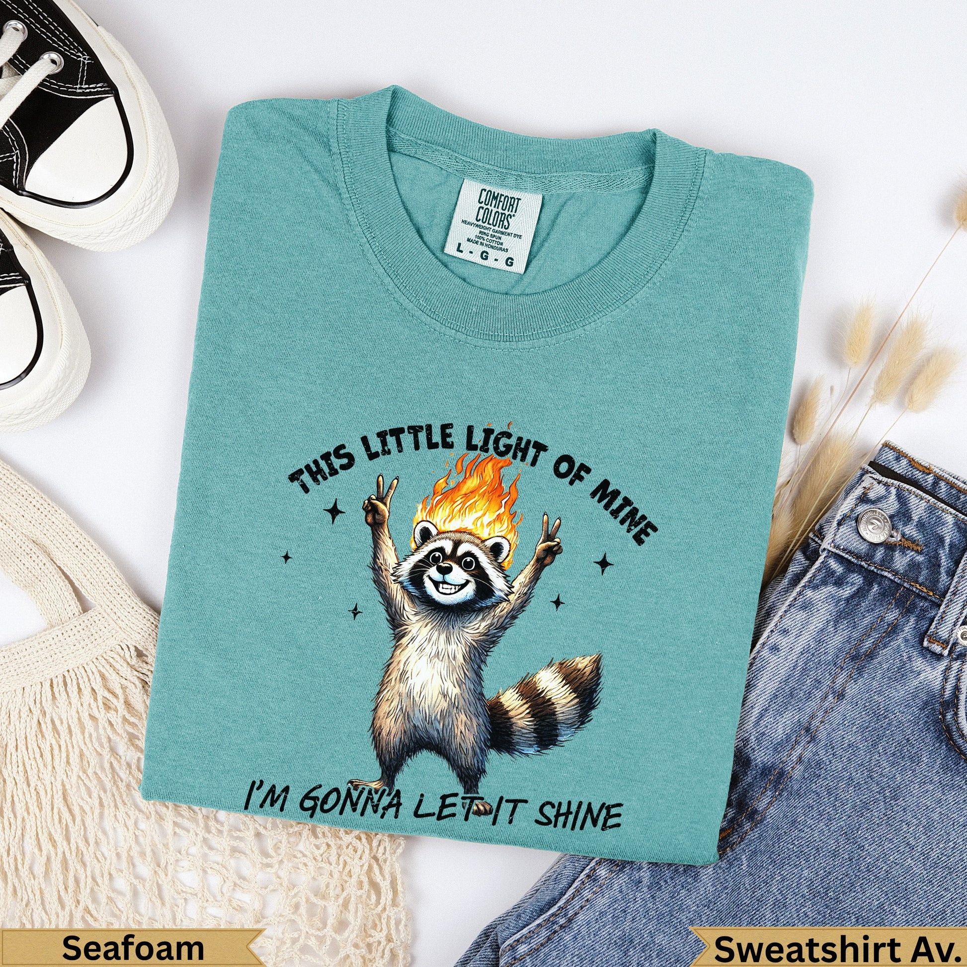 Raccoon with flames on head and peace signs, text "This Little Light of Mine I'm Gonna Let It Shine".