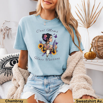 Light blue t-shirt with "Cool Moms Have Tattoos" and floral design.