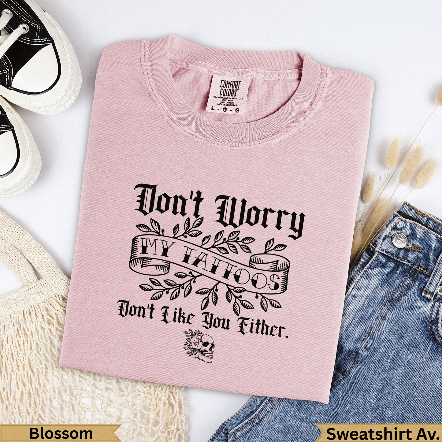 Pink t-shirt with "Don't Worry, My Tattoos Don't Like You Either" text and skull.