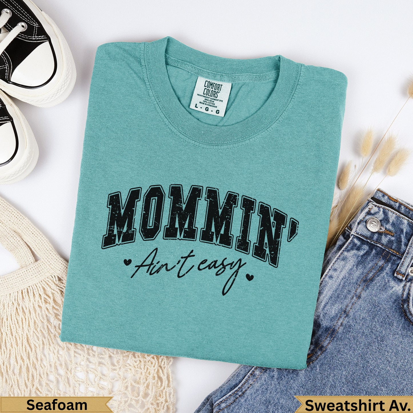 Teal Comfort Colors sweatshirt with "MOMMIN' Ain't easy" graphic.