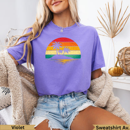 Retro sunset with palm trees on an island, over a woman wearing a purple t-shirt.
