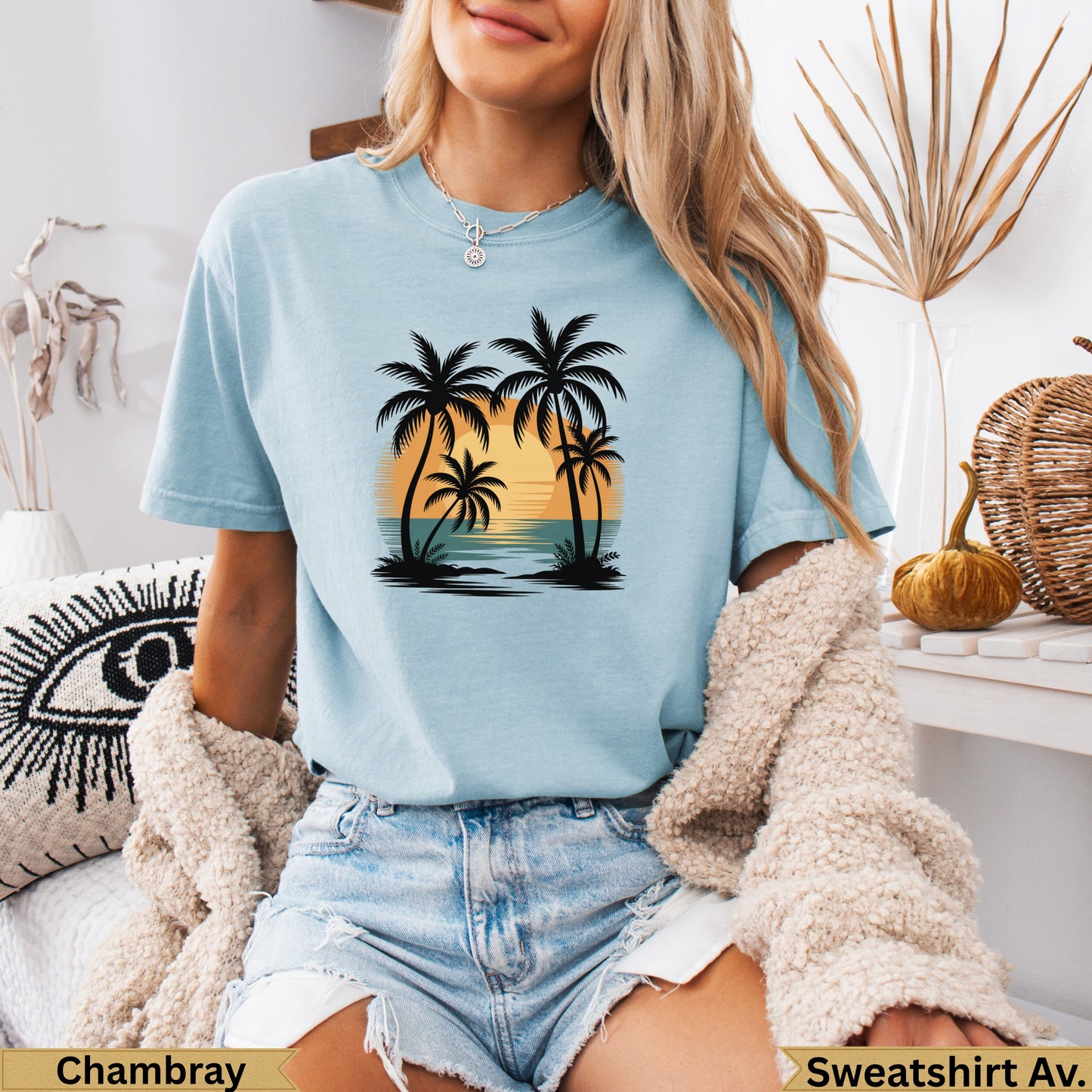 Light blue t-shirt with palm trees and sunset graphic.