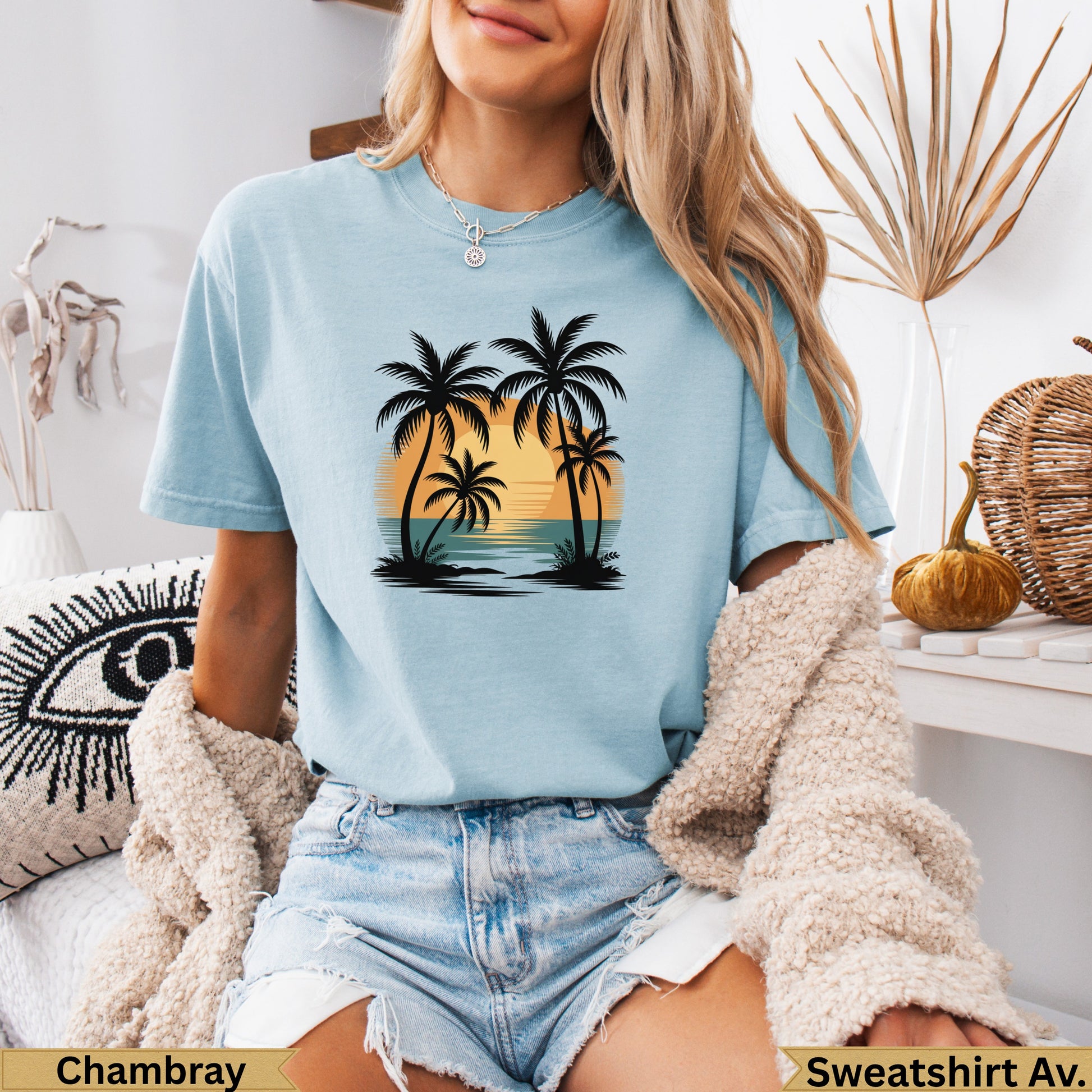Light blue t-shirt with palm trees and sunset graphic.