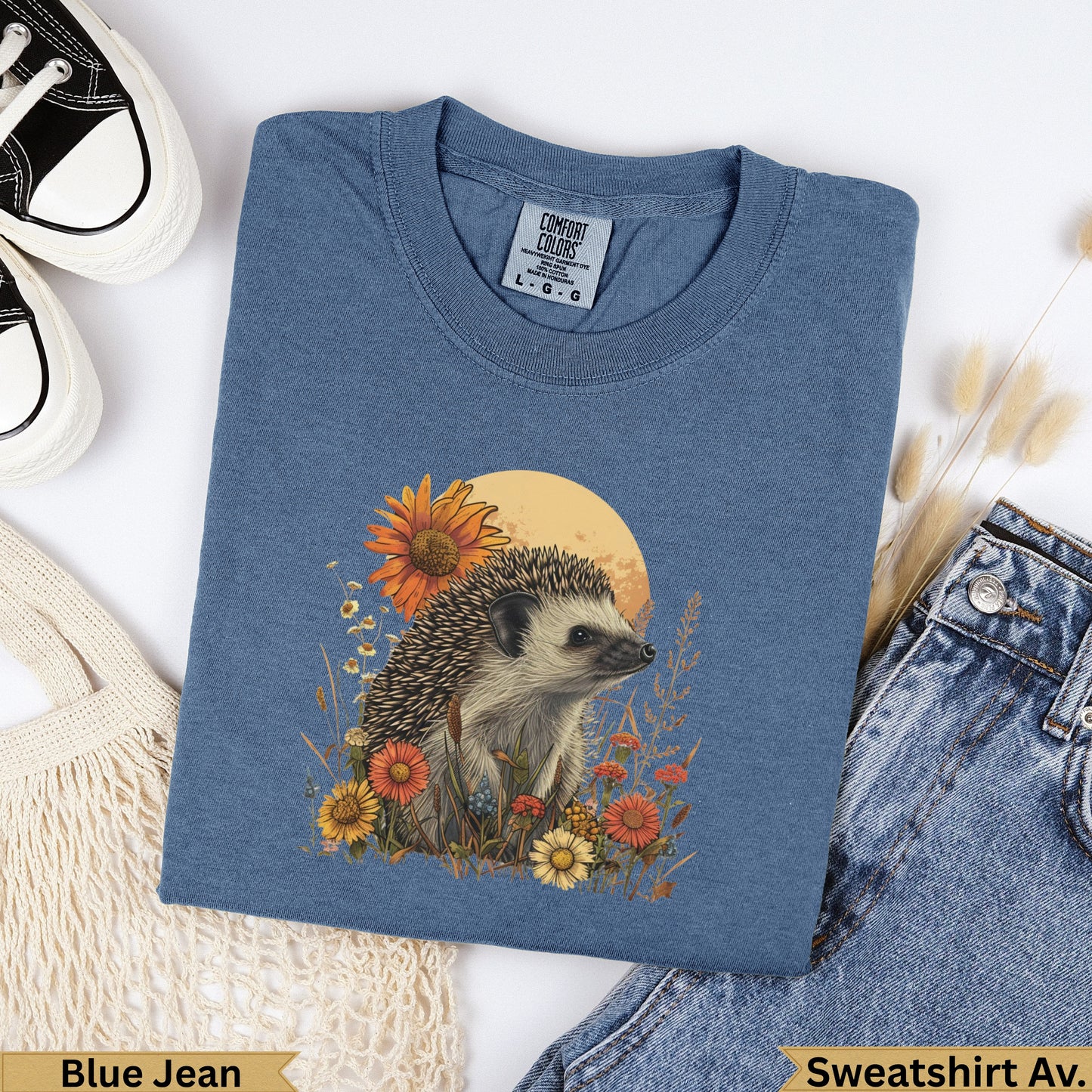 Hedgehog with flowers and moon graphic on blue jean Comfort Colors sweatshirt.
