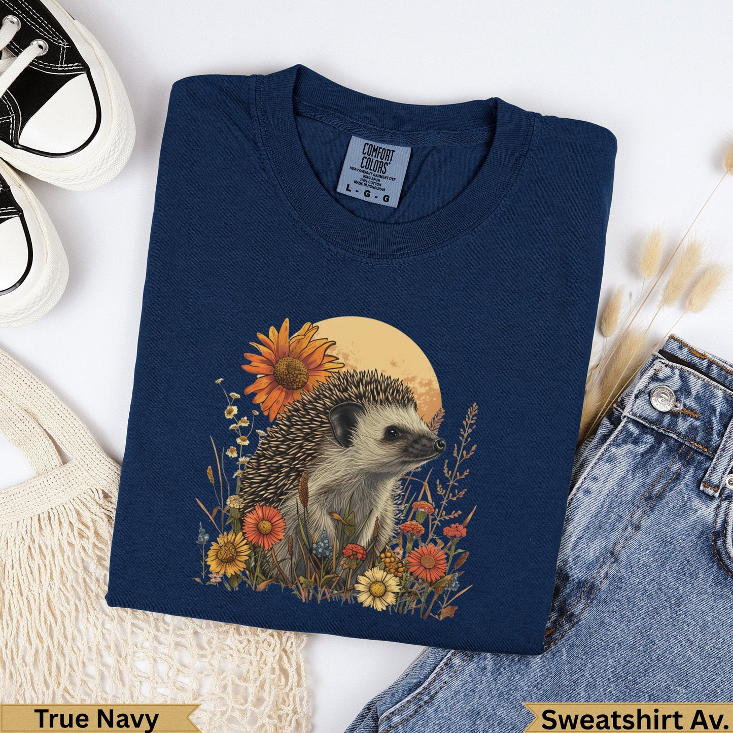 Navy blue sweatshirt with hedgehog and wildflowers graphic and "True Navy" text.
