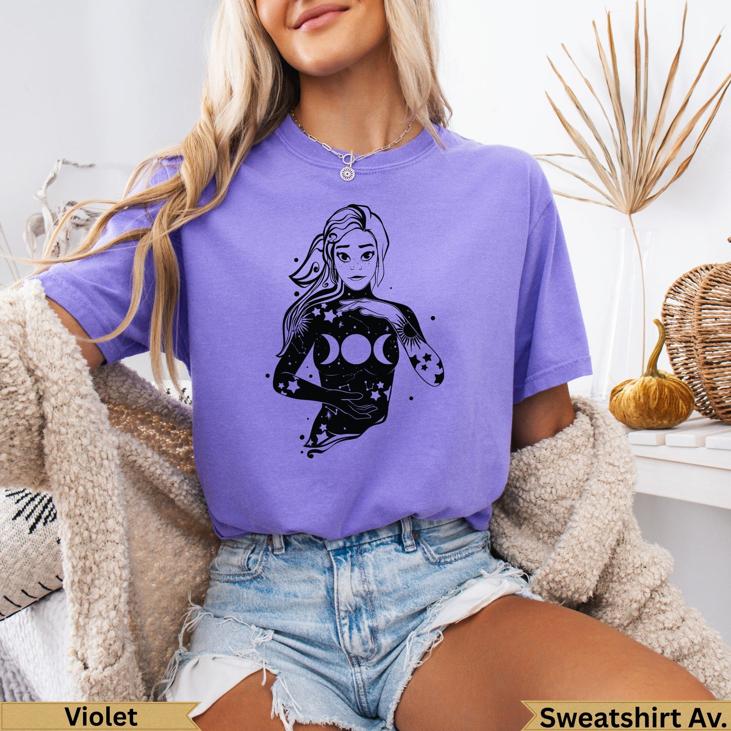 Woman in purple t-shirt with celestial design.