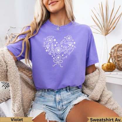 Purple t-shirt with white floral design and "growing glowing" text.