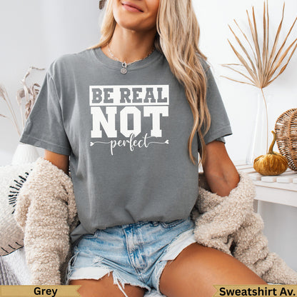 Grey graphic t-shirt with "BE REAL not perfect" text, worn by a model.