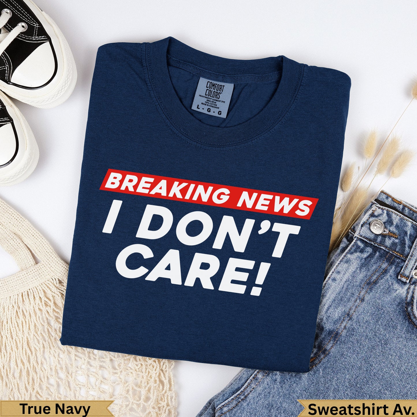 Navy blue t-shirt with "BREAKING NEWS I DON'T CARE!" graphic.