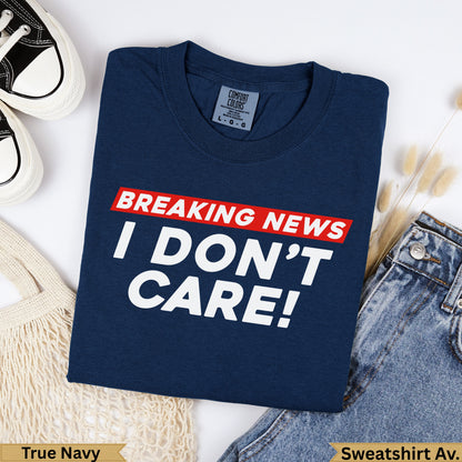 Navy blue t-shirt with "BREAKING NEWS I DON'T CARE!" graphic.
