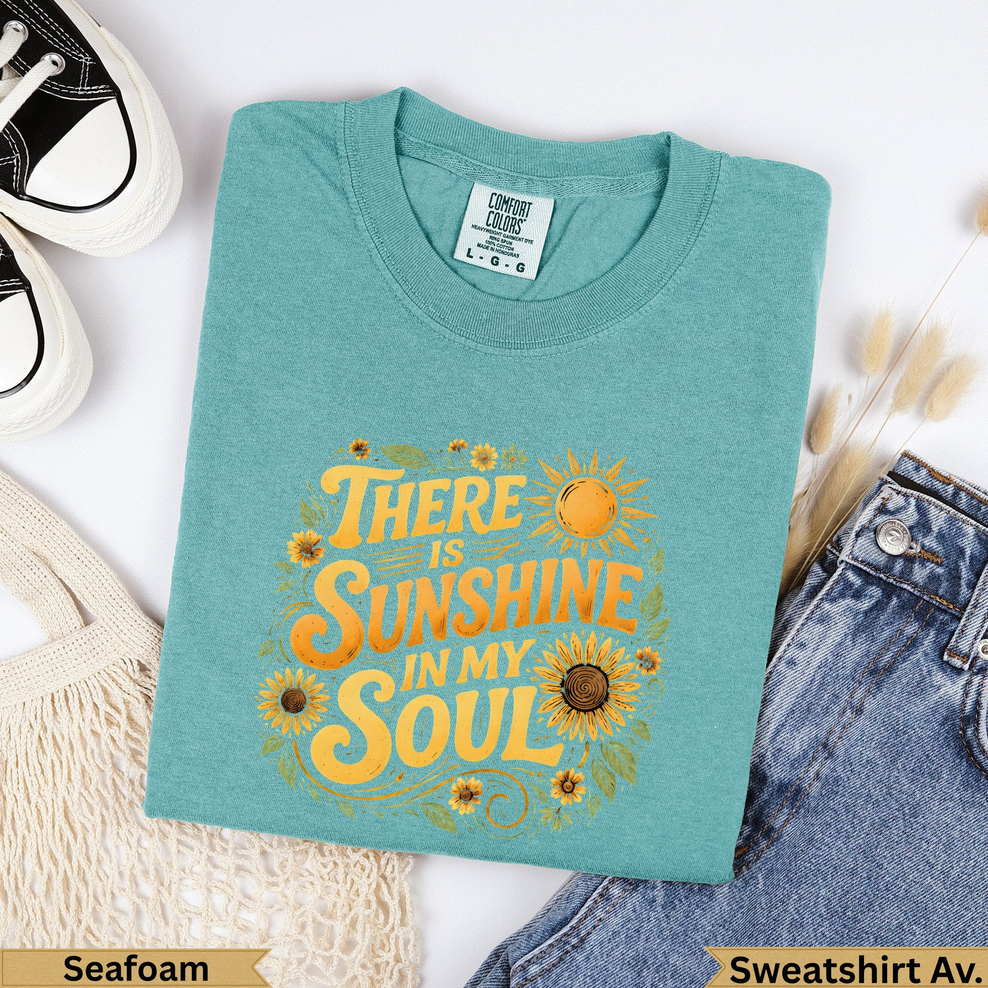Teal t-shirt with "There is sunshine in my soul" and sunflowers graphic.
