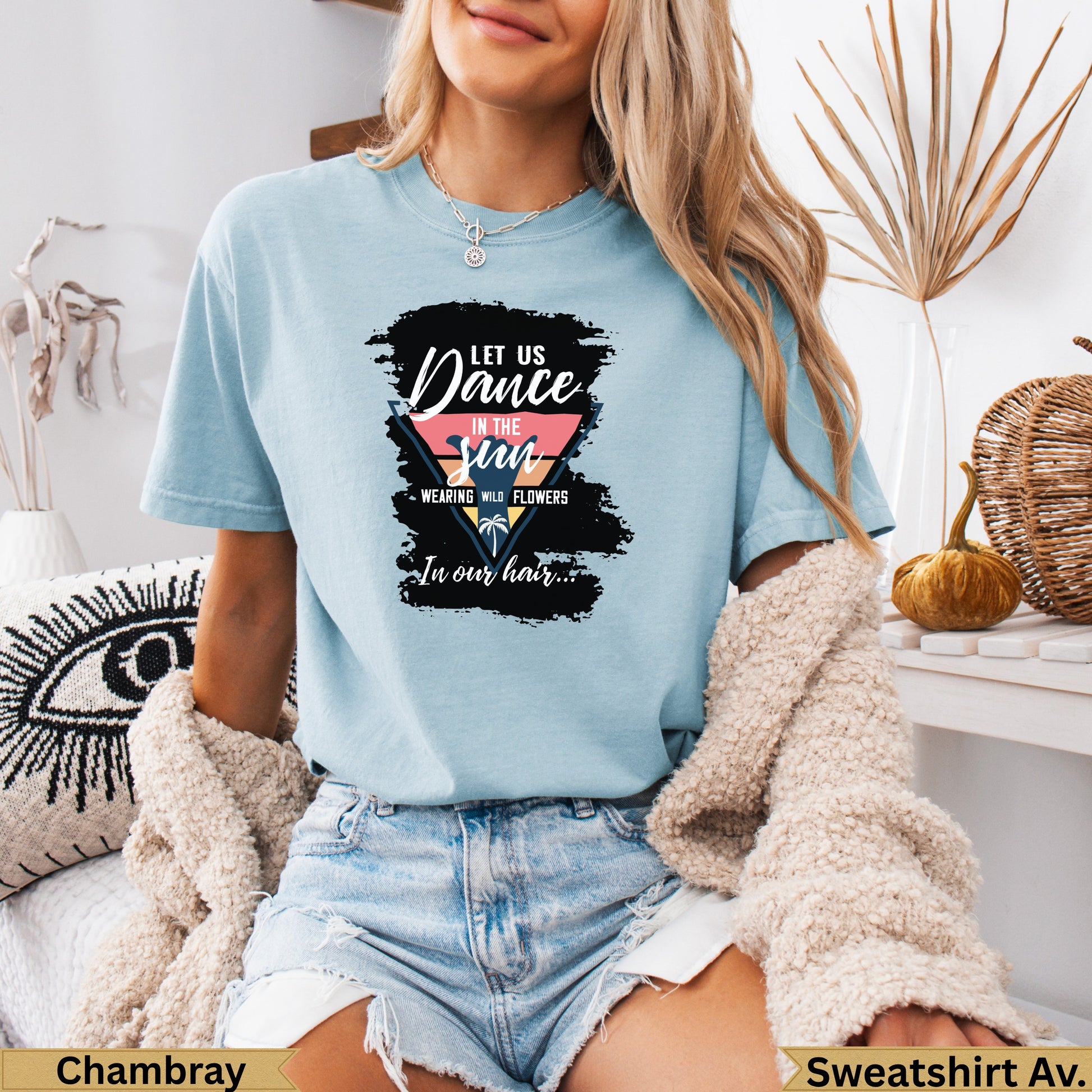Light blue t-shirt with "Let Us Dance In The Sun" text and floral design.