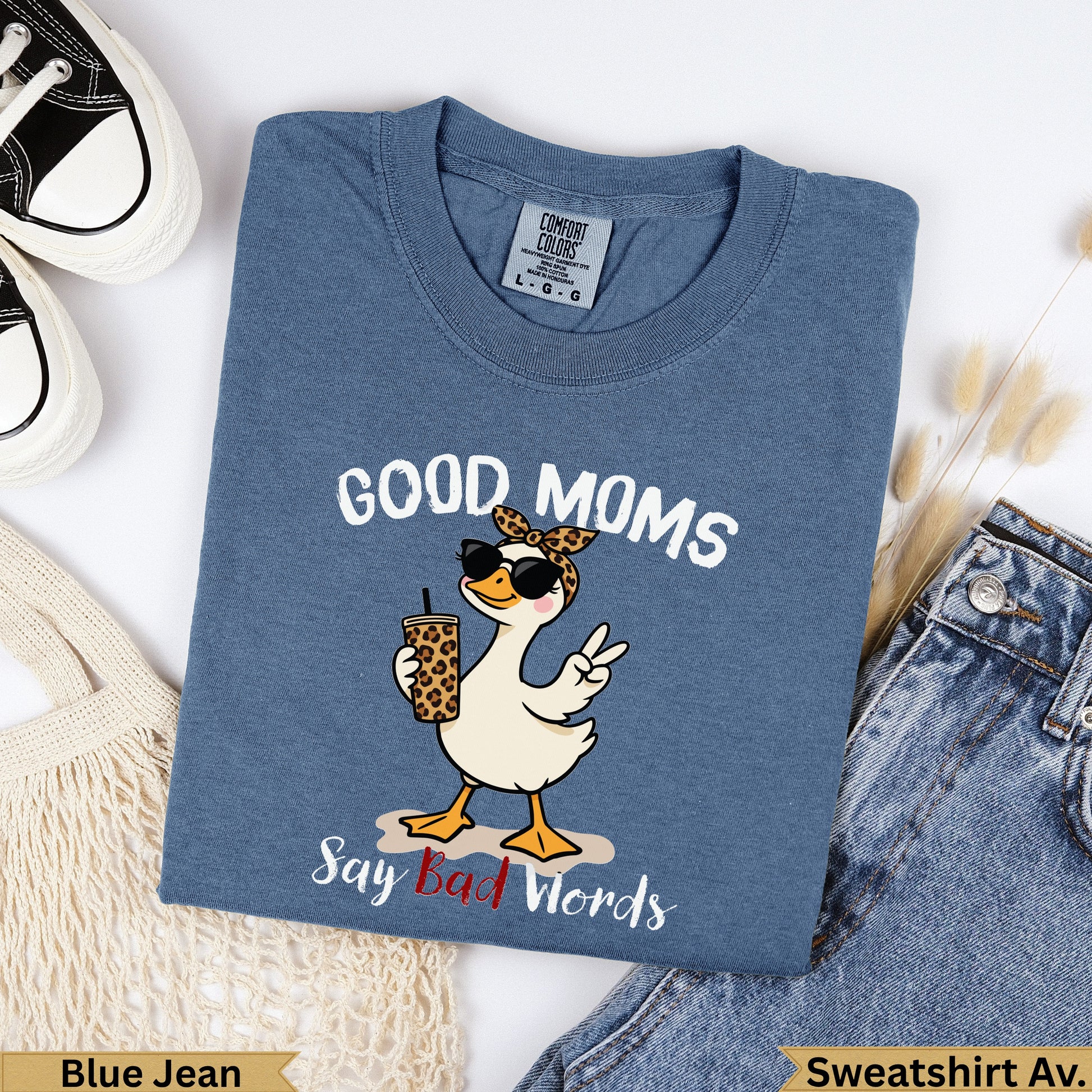 Blue t-shirt with cartoon goose wearing sunglasses saying "Good Moms Say Bad Words."