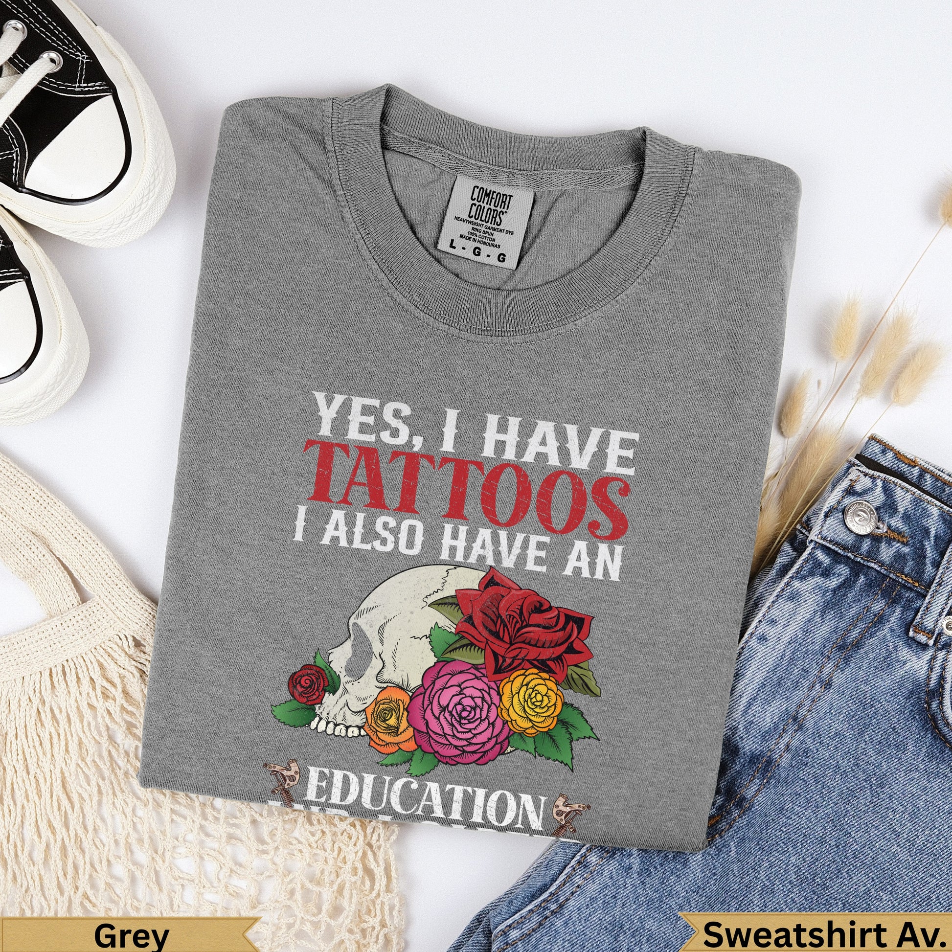 Grey Comfort Colors sweatshirt with skull, roses, and "YES, I HAVE TATTOOS I ALSO HAVE AN EDUCATION" text.
