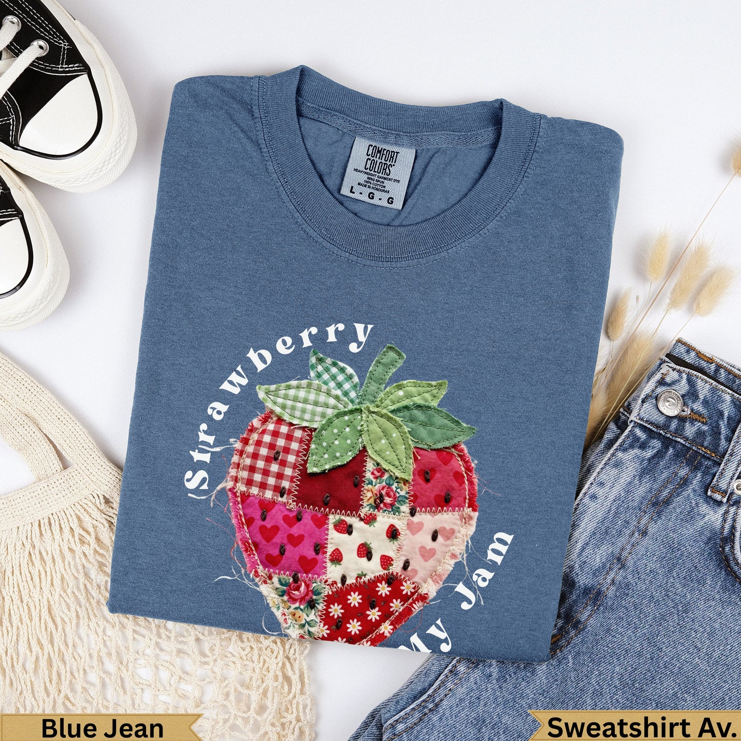 Blue Jean Comfort Colors sweatshirt with a patchwork strawberry and "Strawberry ly Jam" text.