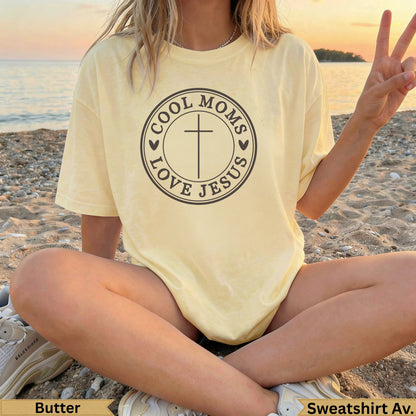 Butter yellow sweatshirt with "Cool Moms Love Jesus" text and cross.