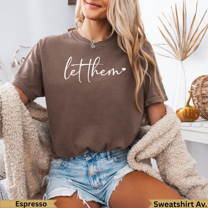 Brown t-shirt with "let them" graphic, worn by a model.