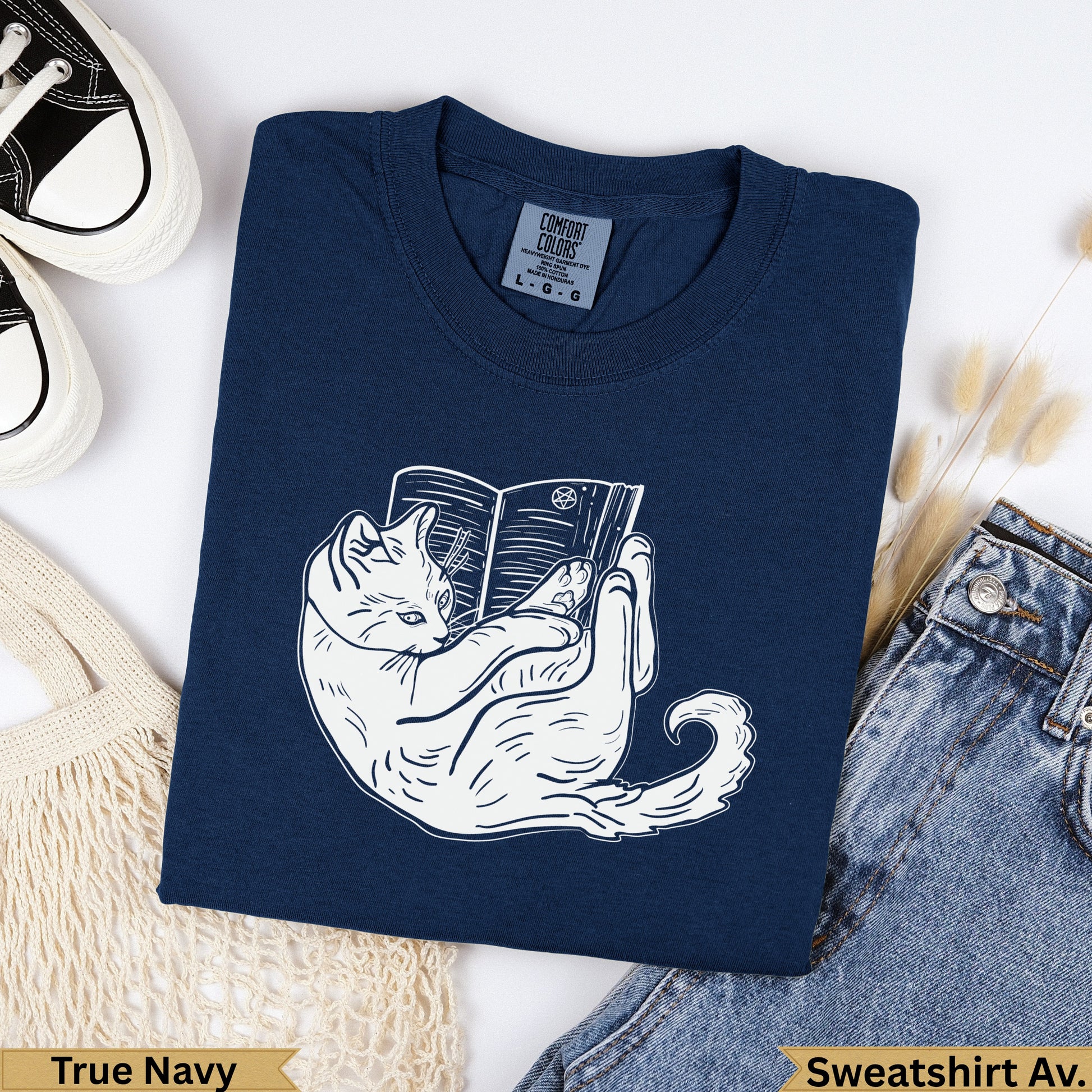 Navy blue sweatshirt with white cat reading a book graphic and "True Navy" text.