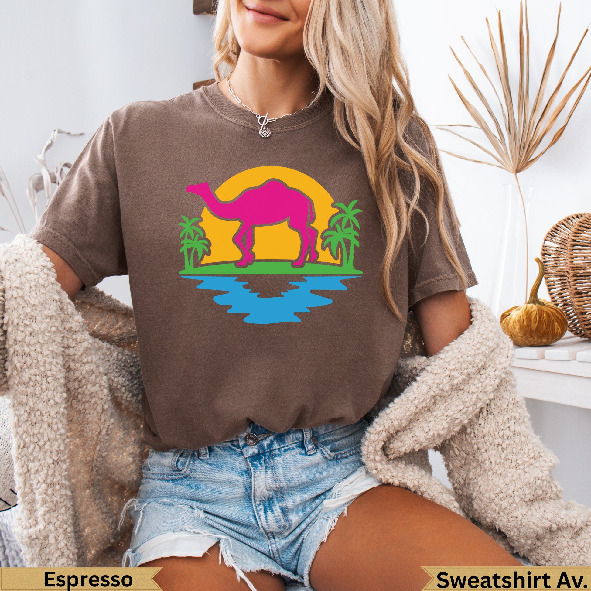 Brown t-shirt with pink camel graphic and palm trees.