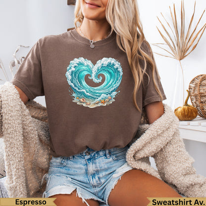Brown t-shirt with a heart-shaped wave, seashells, and sand graphic.