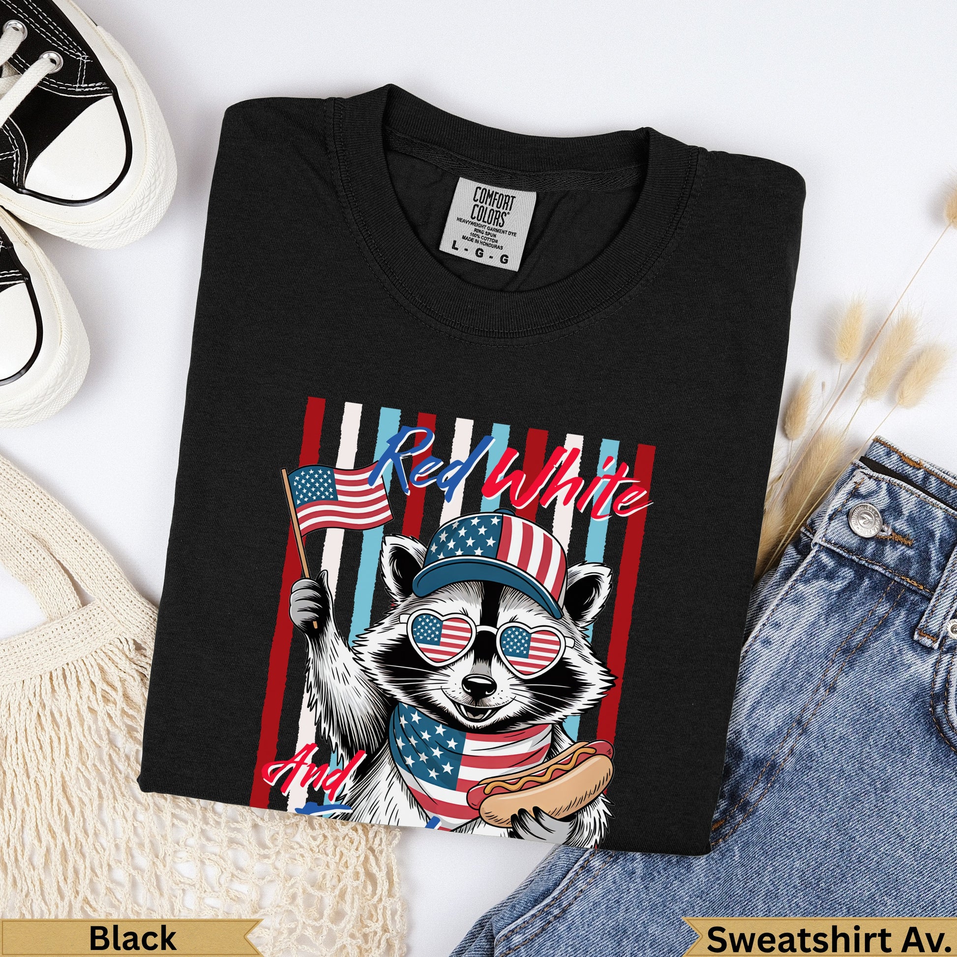 Black t-shirt with patriotic raccoon holding flag and hot dog.