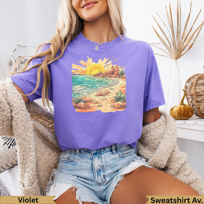 Purple t-shirt with a sunset beach graphic.