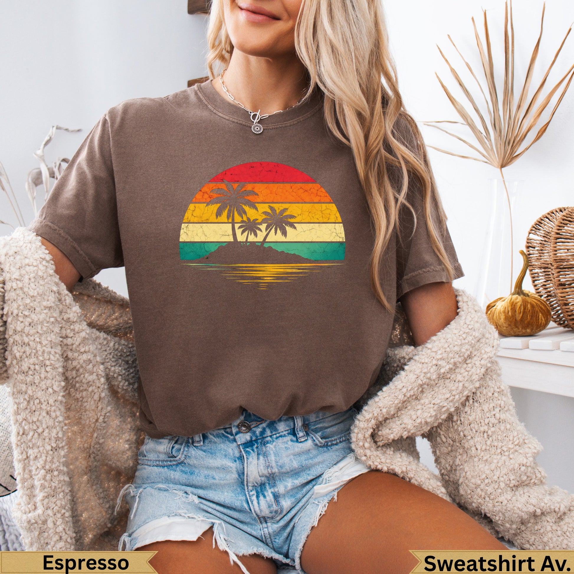 Sunset over ocean with palm trees, on a brown t-shirt.