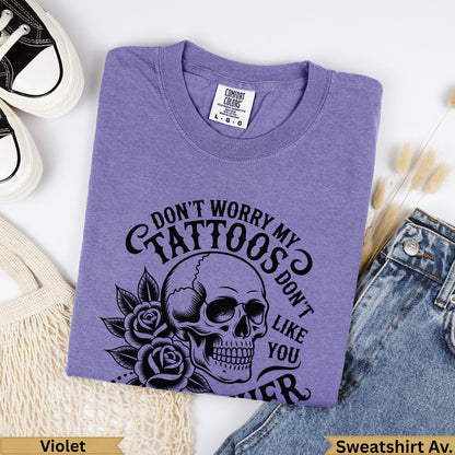 Purple graphic t-shirt with skull and roses design reading "Don't Worry My Tattoos Don't Like You".