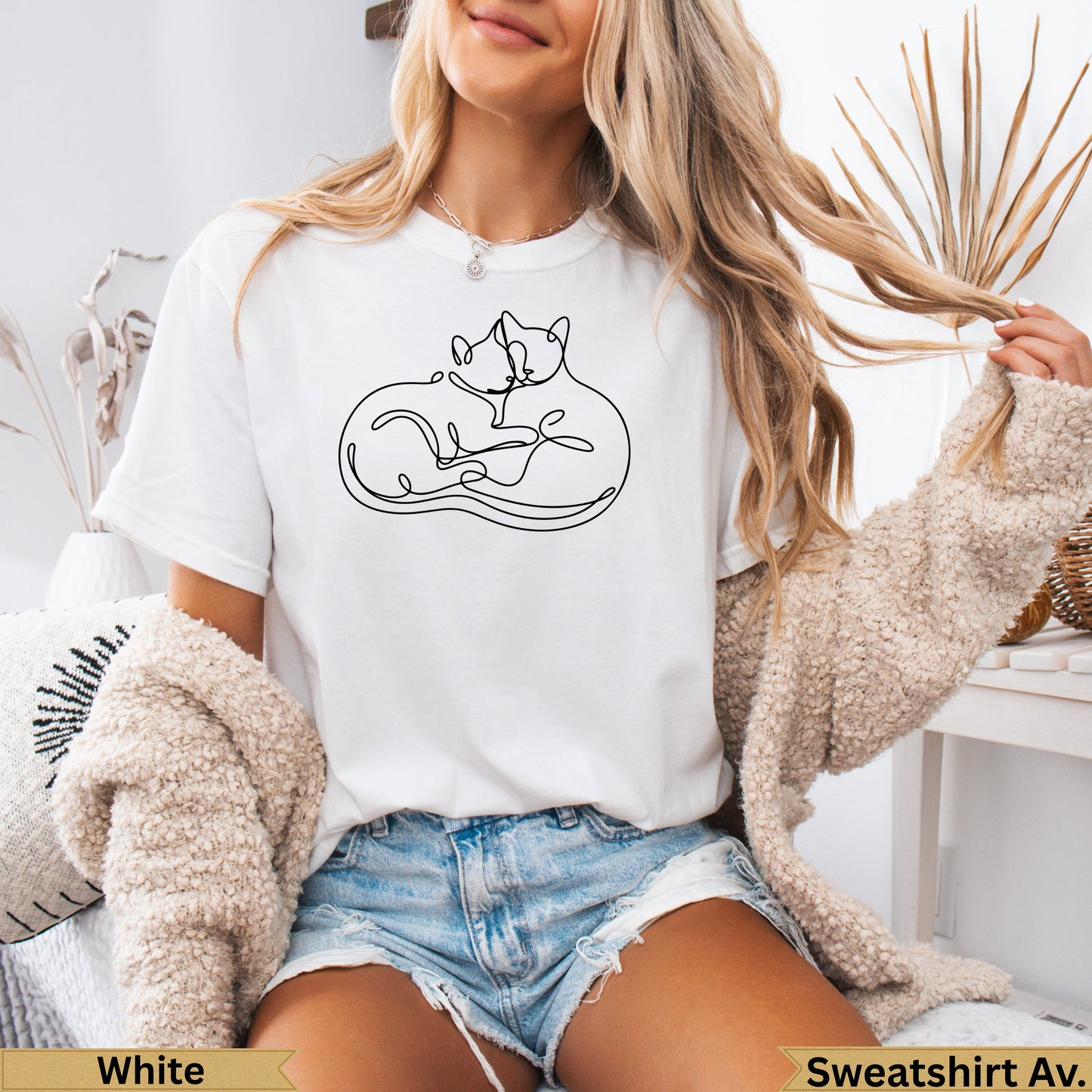 White t-shirt with intertwined cat outline design.