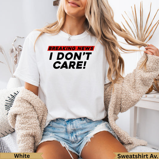 White t-shirt with "BREAKING NEWS I DON'T CARE!" graphic.