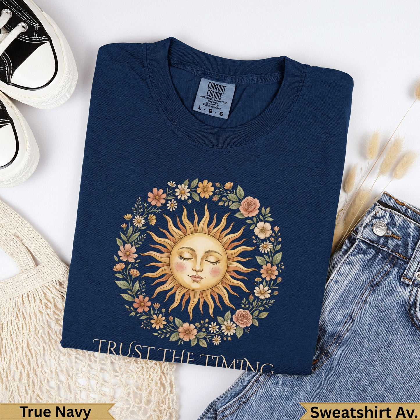Navy t-shirt with "Trust The Timing" text and a sun with floral wreath.