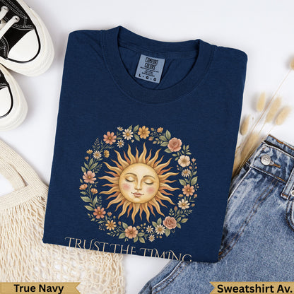 Navy t-shirt with "Trust The Timing" text and a sun with floral wreath.
