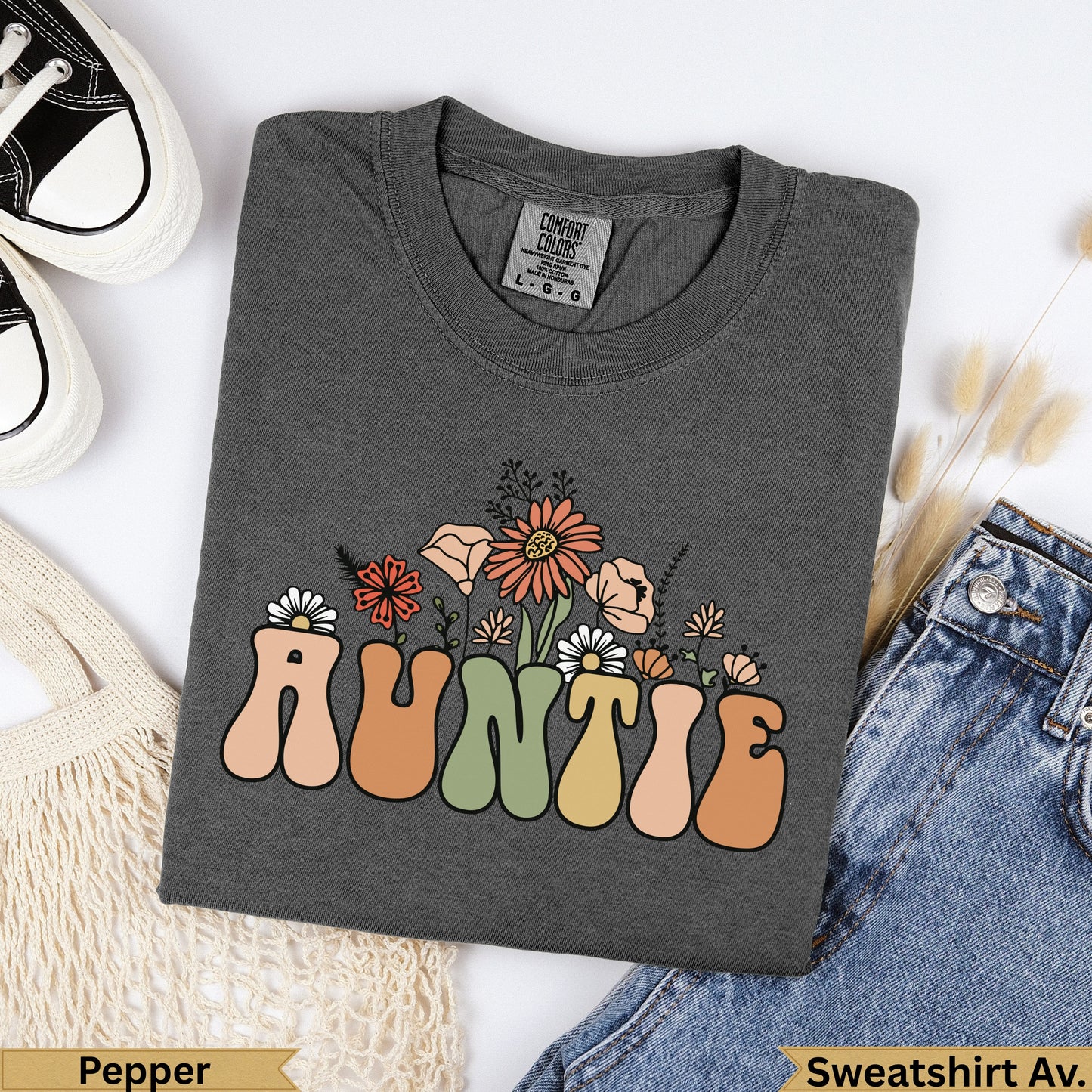 Dark grey t-shirt with "Auntie" in retro font and floral accents.