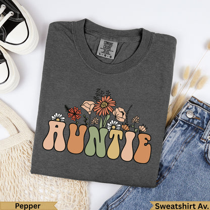 Dark grey t-shirt with "Auntie" in retro font and floral accents.