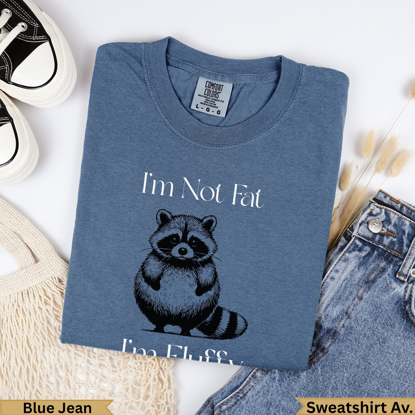 Blue t-shirt with "I'm Not Fat, I'm Fluffy" and a raccoon graphic.