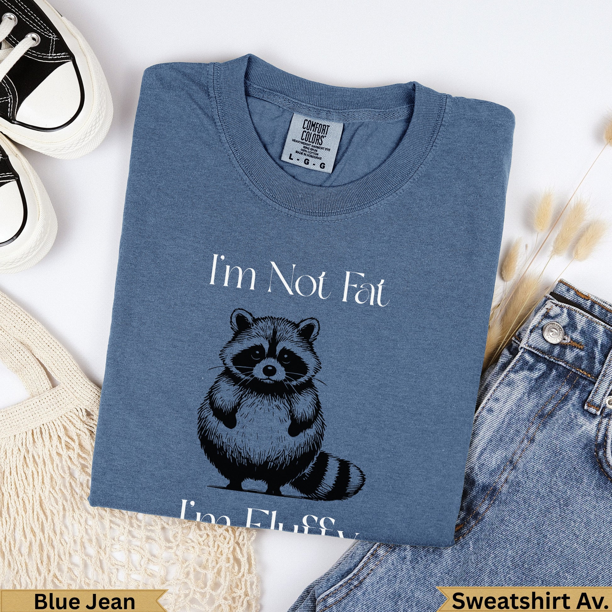 Blue t-shirt with "I'm Not Fat, I'm Fluffy" and a raccoon graphic.