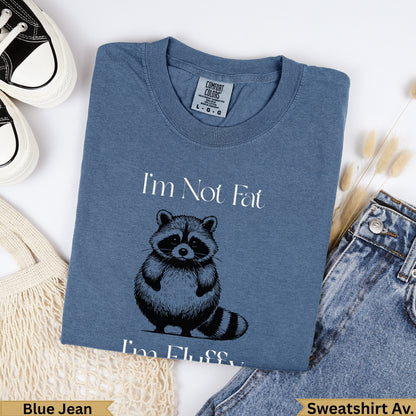 Blue t-shirt with "I'm Not Fat, I'm Fluffy" and a raccoon graphic.