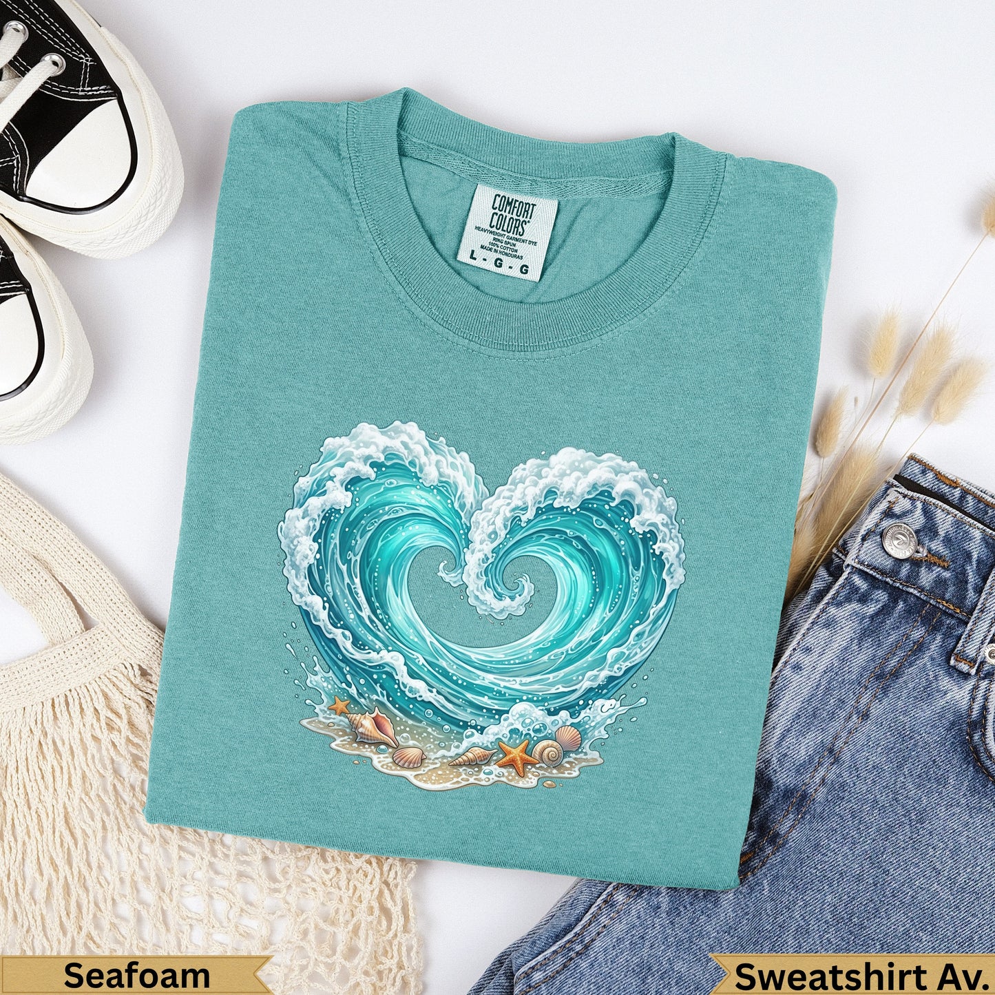 Teal t-shirt with a heart-shaped ocean wave graphic and "Seafoam" text.