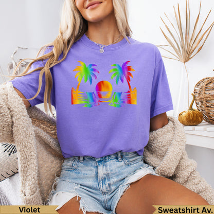 Purple t-shirt with a sunset beach scene graphic in rainbow colors.
